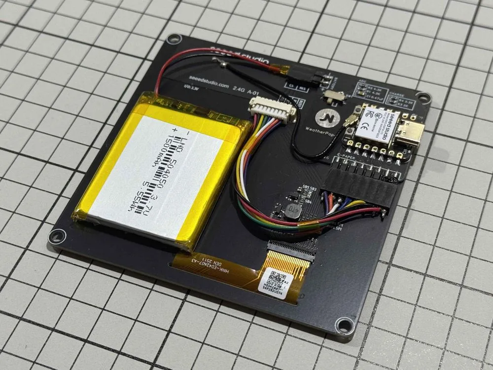 WeatherPaper's custom PCB, battery, display, and XIAO ESP32-C3