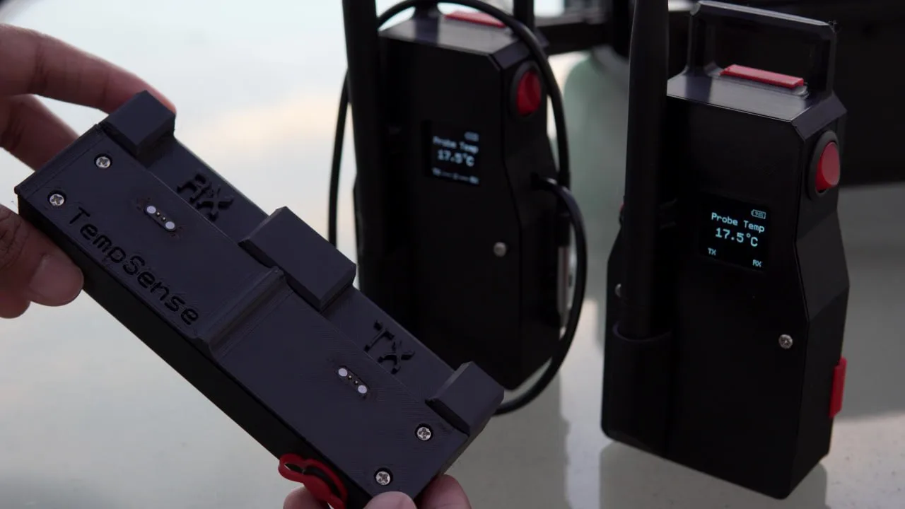 Close-up of the TempSense TX and RX modules showing their labeled pogo-pin connectors